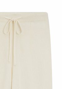 Krämfärgade byxor med en mjuk textur, som har en ribbad midjeband och justerbar dragsko. Enkla raka bendesign.