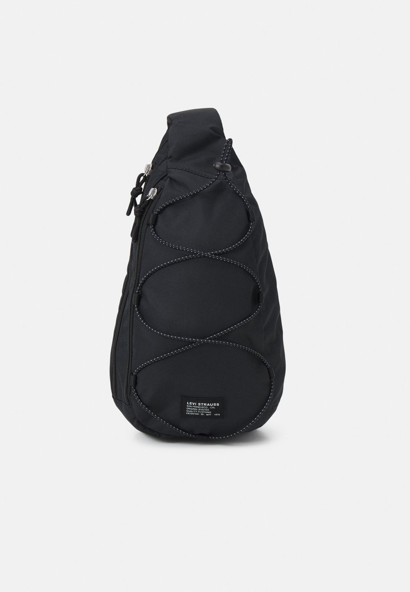 Black Levi's sling backpack with adjustable strap, front bungee cord, zipper pockets, and Levi Strauss branded patch on front.