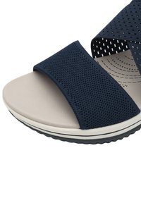 Navy blue open-toe sandal with mesh fabric straps and a cushioned beige footbed. Features a textured black rubber sole with white detailing.
