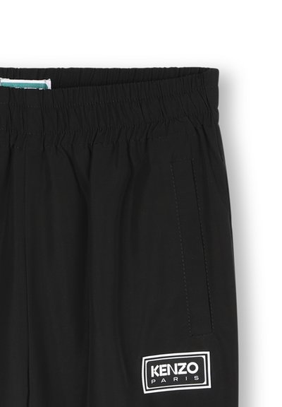 Zwarte elastische taillebroek met een gladde textuur, zijzakken en een wit merklogo met "KENZO PARIS."