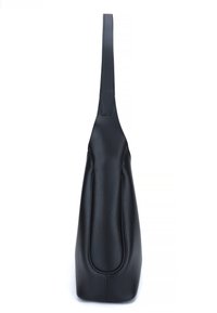 Black leather bag with a smooth texture, a single elongated handle, and a minimalist design; features a rounded base and subtle stitching details.