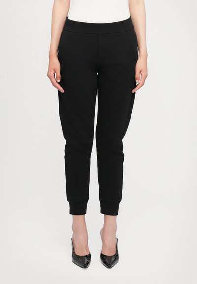 Pantalons de jogging noirs en tissu doux, avec une taille élastique, des ourlets resserrés et des poches latérales pour plus de praticité.