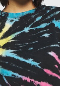 Black tie-dye t-shirt with splashes of yellow, blue, and pink. Features a crew neckline and soft cotton texture. No additional patterns.
