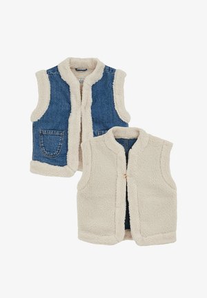 Dvoje nohavic: jedny džínové s sherpa podšívkou a golierom, druhé plne sherpa v béžovej farbe s predným zipsom. Oba nemajú rukávy a majú bočné vrecká.