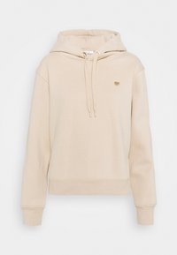 Beige mikina s kapucí z měkkého materiálu a volným střihem. Obsahuje šňůrku na kapuci, žebrované manžety a malou zlatou srdíčkovou nášivku na hrudi.
