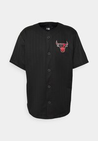 Camisa negra de botones con mangas cortas, que presenta rayas verticales y un colorido logo de los Chicago Bulls bordado en el pecho izquierdo.