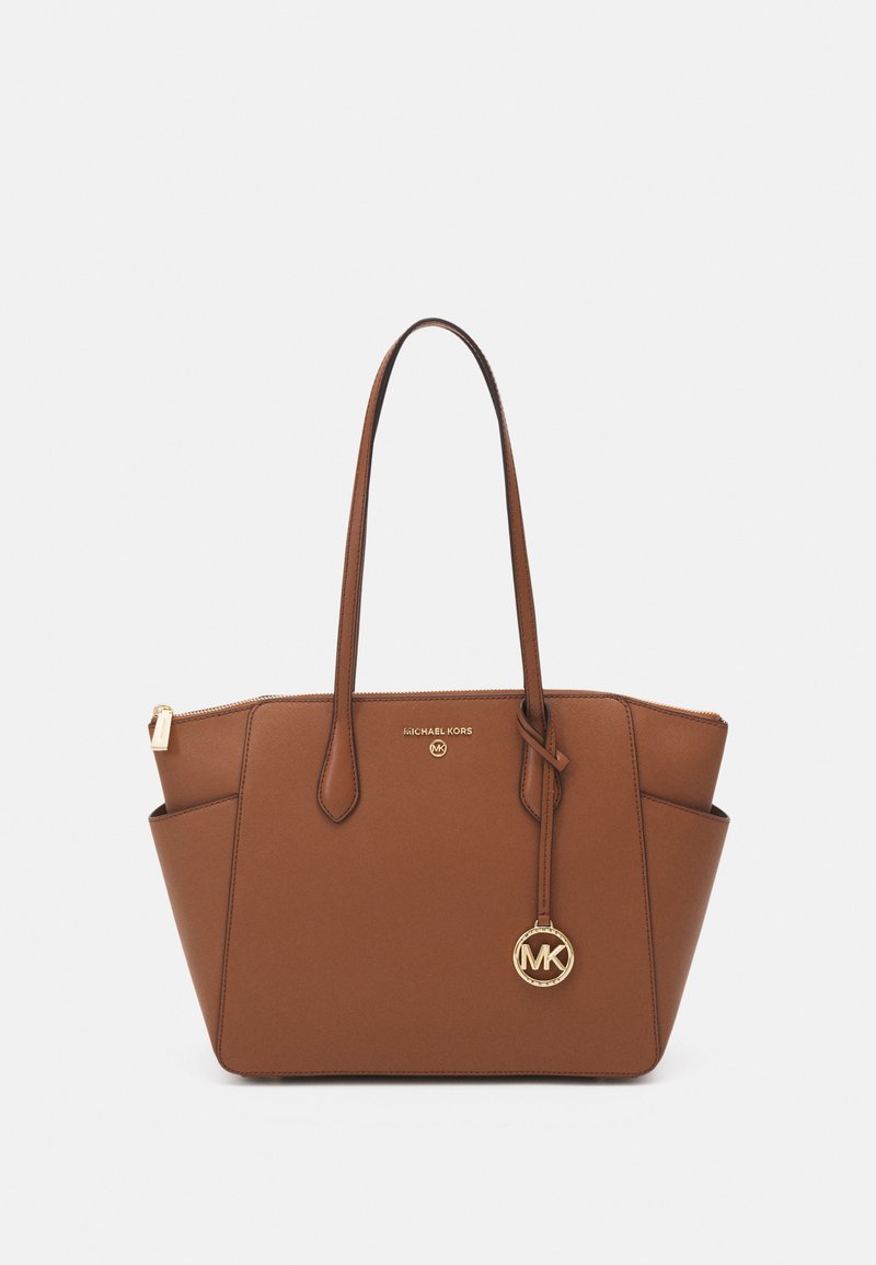Brown synthetic tote bag with dual top handles, gold hardware, zip closure, and an MK logo charm. Features a structured design.