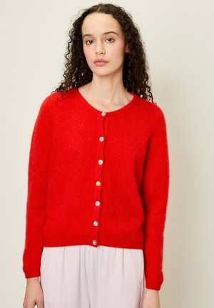 Red, fluffy cardigan with a round neckline and long sleeves. Features a row of six multi-colored buttons down the front. Soft texture.