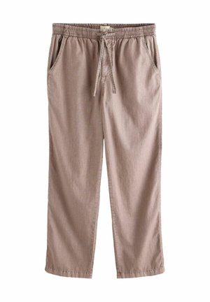 Beige lässige Hose mit elastischem Bund und Kordelzug, geraden Beinen und Seitentaschen, flach auf weißem Hintergrund ausgelegt.