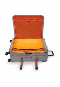 Grijze koffer met een oranje interieur. Beschikt over twee gaasvakjes, riemen om spullen vast te zetten, een combinatie slot en vier wielen voor mobiliteit.