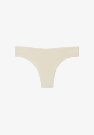Tanga beige hecho de un suave tejido acanalado. Presenta un diseño de talle bajo con un estilo minimalista y bordes suaves.