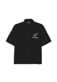 Black short-sleeve button-up shirt with a collar, white wing graphic, and "TRUST THE PROCESS" text on the left chest.