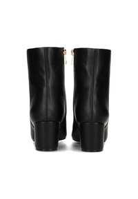 Botas de tobillo de cuero negro con una textura suave, tacones cuadrados y cremalleras laterales. Presentan un diseño minimalista y un corte recto.