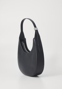 Black leather handbag with a rounded silhouette, a wide strap, and a zippered interior, featuring smooth texture and minimalistic design.