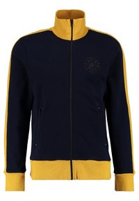 Marinblå zip-jacka med gula accenter, hög krage, två sidofickor och en solgrafik på vänster sida. Mjuk tyg och ribbade ärmslut.