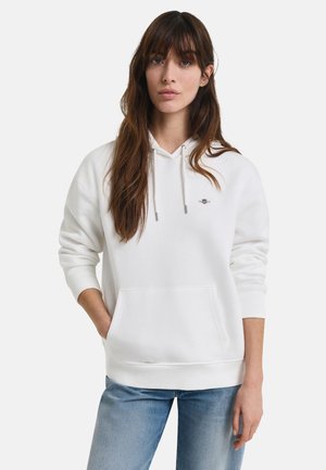 Valkoinen huppari, jossa on kenguru-tasku, naru-huppu, ribbireunat ja hillitty brodeerattu logo rinnassa. Pehmeä tekstuuri.