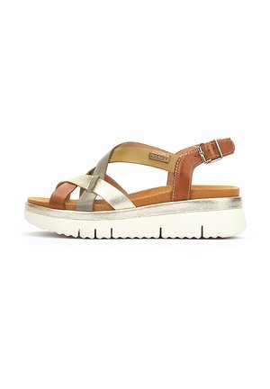 Sandalias de cuero marrón, dorado y plateado con correas cruzadas, correa de tobillo ajustable, plantilla acolchada y suela de plataforma blanca.
