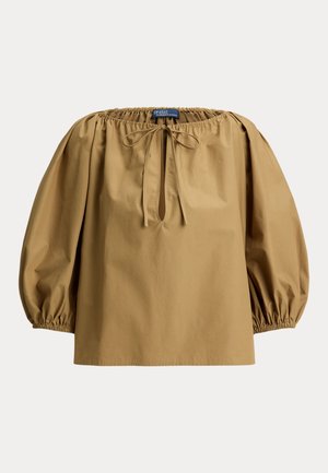 Hnedá bavlnená blúzka so zúženým výstrihom, balónovými rukávmi a zaväzovaním na krku. Hladká textúra a voľný strih.