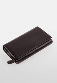 Brown leather wallet with a smooth texture, rectangular shape, and a zippered compartment. Features a logo embossed on the front.