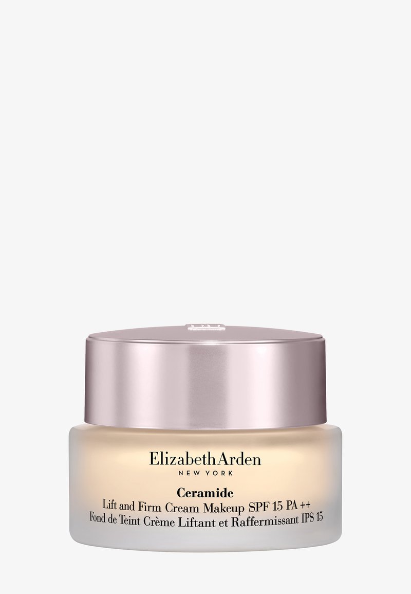 Krem Ceramide Lift and Firm Makeup w okrągłym szklanym opakowaniu. Miękki krem o przezroczystej bazie, metalicznie różowa pokrywka, czarny tekst i detale.