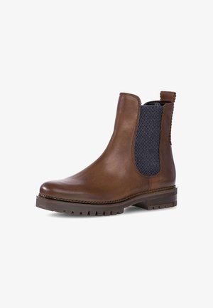 Bottine Chelsea en cuir marron avec des panneaux élastiques sur les côtés, des accents en tissu texturé, un bout rond et une semelle en caoutchouc durable.