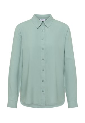 Chemise à manches longues vert clair avec col pointu et manches boutonnées, étiquetée Cecil.