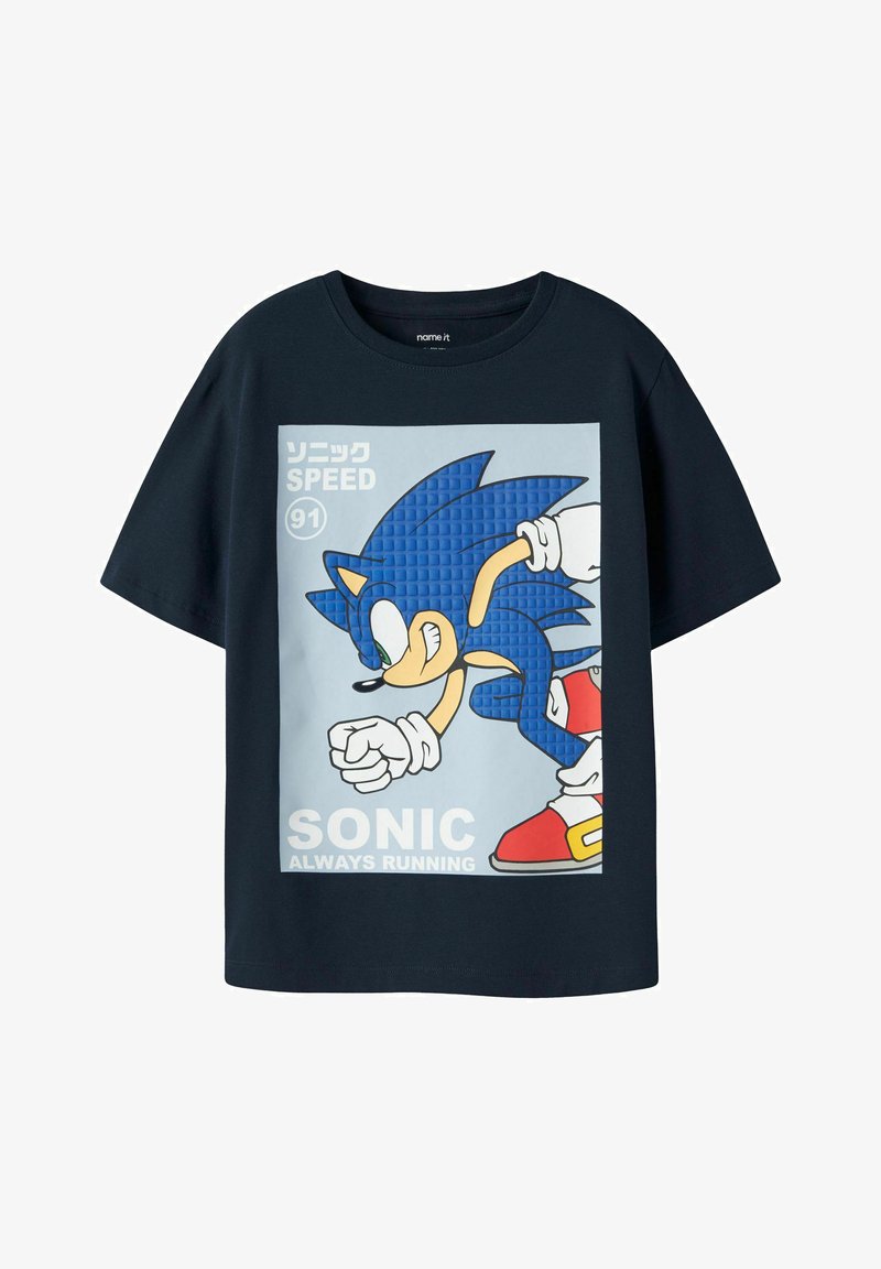 Μπλε μπλουζάκι με γραφικά του Sonic the Hedgehog που τρέχει, κείμενο "Sonic Always Running", "Speed 91" και ιαπωνικούς χαρακτήρες πάνω αριστερά.