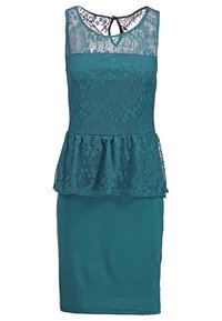 Türkises Peplum-Kleid mit Spitze über dem Oberteil, ärmelloses Design, Schlüssellochverschluss am Rücken und tailliertem Rock. Die Spitze zeigt florale Muster.