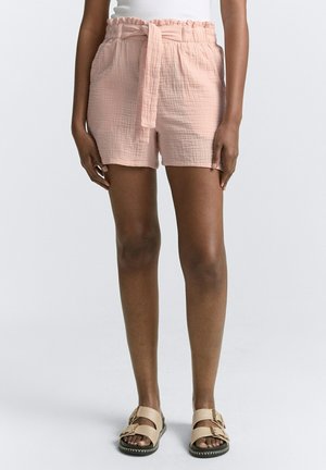 Helle rosa Baumwollshorts mit Strukturmuster, elastischem Taillenbund und gebundenem Gürtel. Mit seitlichen Taschen und lockerem Sitz.