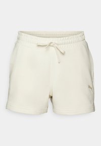 Crèmekleurige shorts met een elastische tailleband, trekkoordsluiting en zijzakken. Voorzien van een subtiele logo-afwerking op de voorkant.
