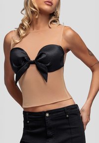 Czarny satynowy gorset z przodu z kokardą na nude przezroczystej siateczce. Top z cienkimi ramiączkami i dopasowanym krojem.