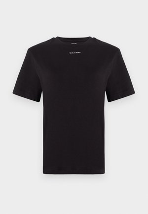 Black cotton t-shirt with short sleeves, crew neck, and small white "Calvin Klein" logo at the chest. Smooth texture, classic fit.