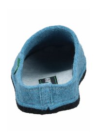 Blue felt indoor slipper with a black sole, rounded shape, and visible stitching. Includes a green loop tag inside the opening.