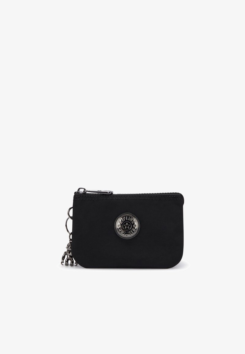 Black zippered wallet made of textile with a smooth texture, featuring a circular branded accent and a small metal chain with charms.