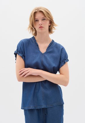 Denim top with a V-neck and ruffled sleeves, featuring a relaxed fit and visible stitching, in a solid blue color.
