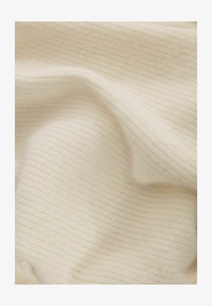 Cream-colored knit fabric with a fine, ribbed texture, draped to show soft, subtle layering and detailing of the weave pattern.