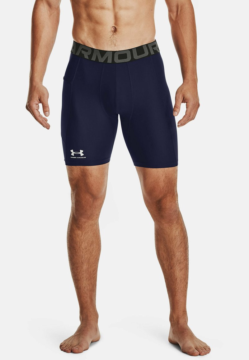 Marineblaue Kompressionsshorts mit einem schwarzen elastischen Bund. Mit dem weißen Under Armour-Logo am unteren linken Bein. Glattes, dehnbares Material.