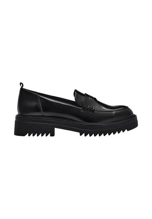 Mocasín negro de cuero con suela gruesa y acanalada, puntera redonda y una tira decorativa sobre el empeine, visto de lado.