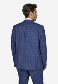 Marineblau karierte Sakkojacke aus strukturiertem Stoff. Slim Fit, mit einem Reverskragen und zwei Schlitzen hinten. Mit passender Hose.