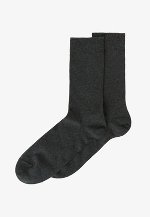 Mørkegrå sokker lavet af et blødt, glat materiale med en almindelig længde, der har en ribbet top og et sømløst tådesign.