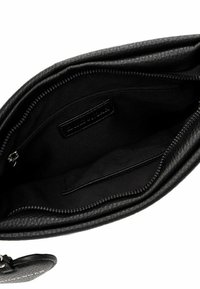Black leather handbag interior with smooth texture. Features a zipper pocket and an open compartment, all lined in black fabric.