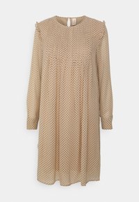 Langärmliges Kleid aus beigem, transparentem Stoff mit einem Polka-Dot-Muster, gerafftem Bund und einem Schlüssel-ausschnitt auf der Rückseite. Mit Rüschendetails an den Schultern.