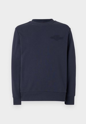 Sweatshirt azul-marinho feito de tecido suave, apresenta um decote redondo, punhos canelados e um detalhe de logótipo cosido no peito.