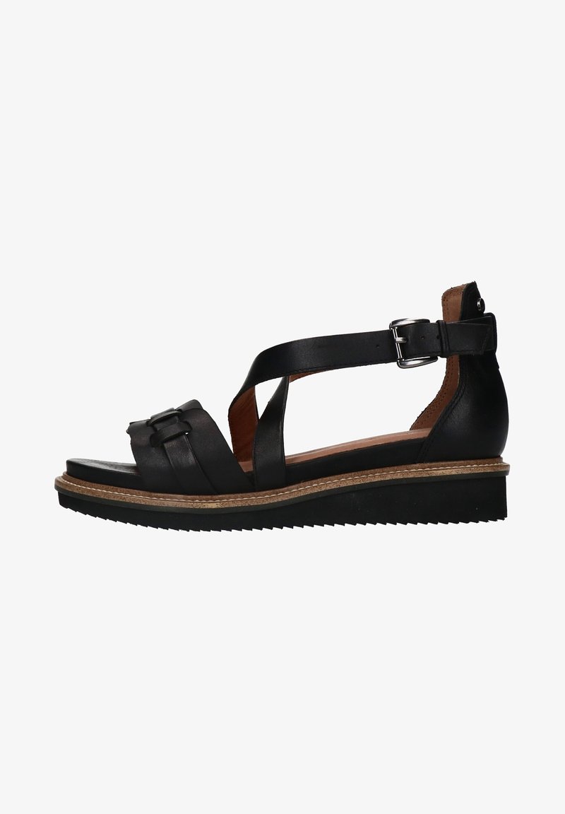 Sandale femme en cuir noir avec bride cheville, fermeture à boucle, semelle compensée basse et semelle extérieure en caoutchouc texturé.