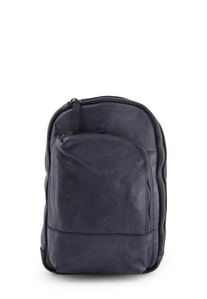 Navy Leder-Rucksack mit gerundeter Form, glatter Oberfläche, vorderer Reißverschlusstasche und kontrastierenden goldfarbenen Reißverschlussbeschlägen.