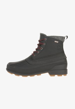 Black waterproof ankle boot with a rubber lower, grey felt collar, red laces, and textured detailing on the upper and sole.