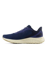 Navy knit athletic shoe with a textured upper, contrasting dark accents, and a light rubber sole. Features a cushioned midsole and lacing system.