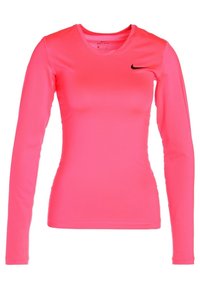 Long-sleeve athletic top in bright pink fabric with a smooth texture, featuring a black Nike logo on the left chest area.