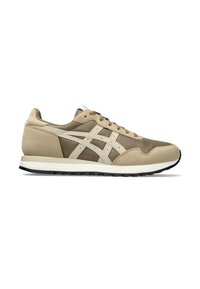 Beige athletic sneakers with a suede and mesh upper, featuring a white wave design, round toe, lace-up front, and black rubber sole.