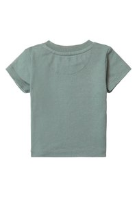 T-shirt à manches courtes en coton doux de couleur vert clair. Encolure arrondie avec de subtils détails de couture. Texture lisse et design simple.